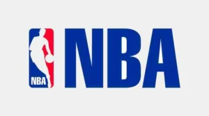 Official logo of NBA: A white and red iconic silhouette of a basketball player dribbling a basketball in front of a blue and red half-circle with the white 'NBA' text placed to the right of the player figure